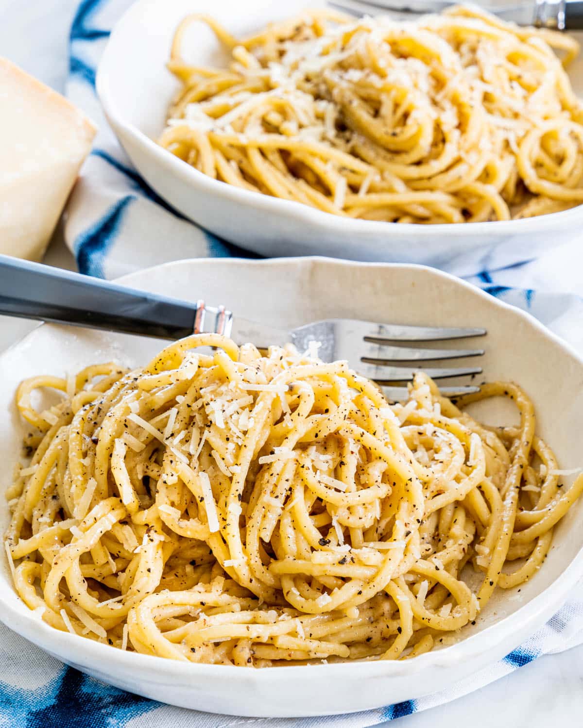 two plates filled with Cacio e Pepe