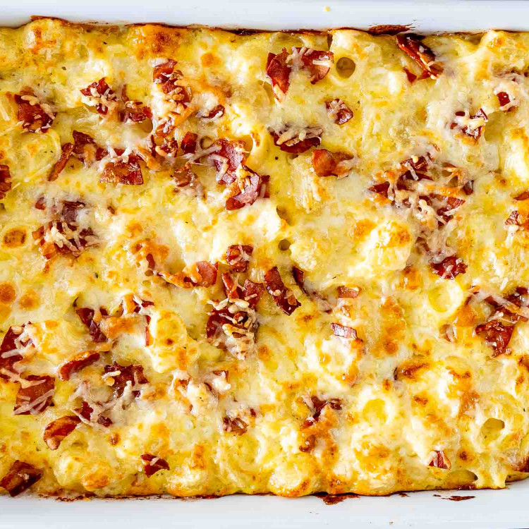 baked carbonara mac and cheese souffle in a casserole dish.