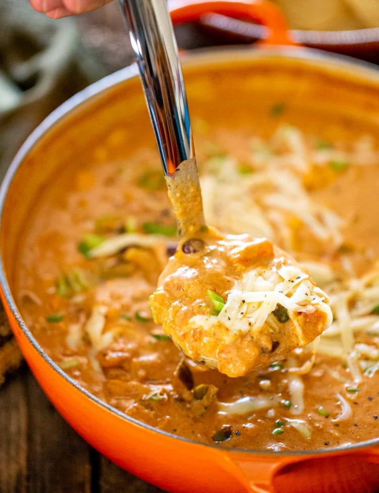 freshly made cheesy chicken enchilada soup in a dutch oven.