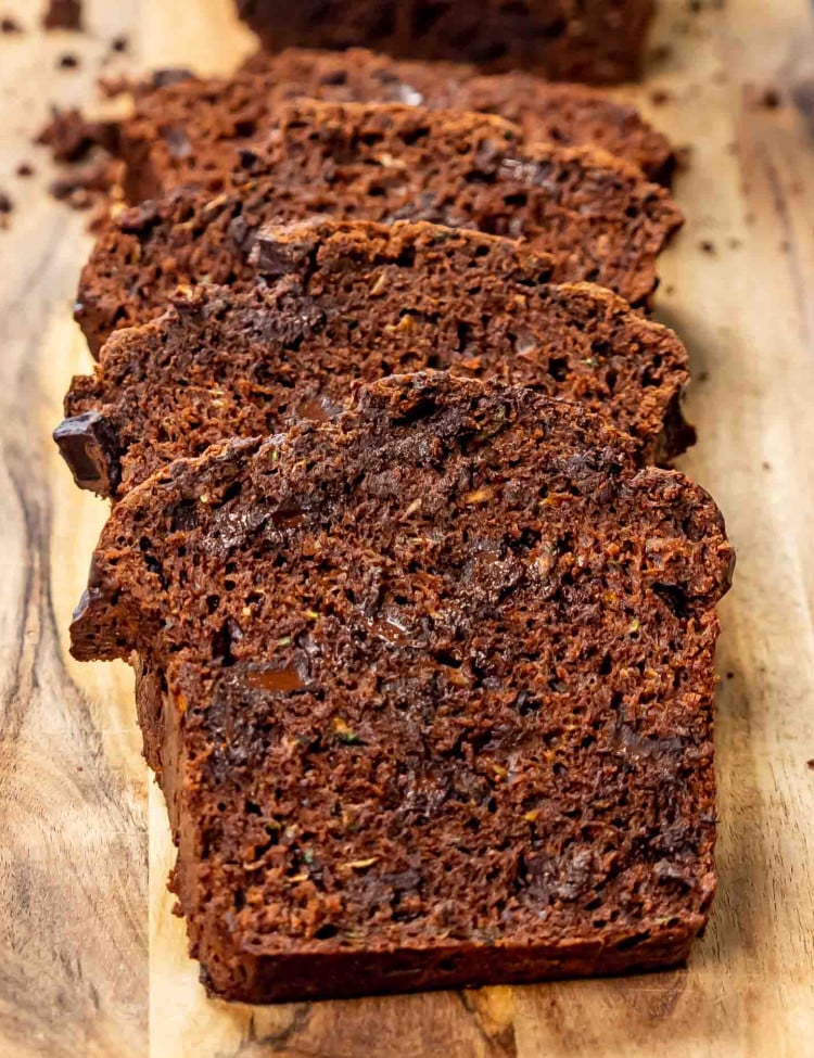 sliced up chocolate zucchini bread on a cutting board.
