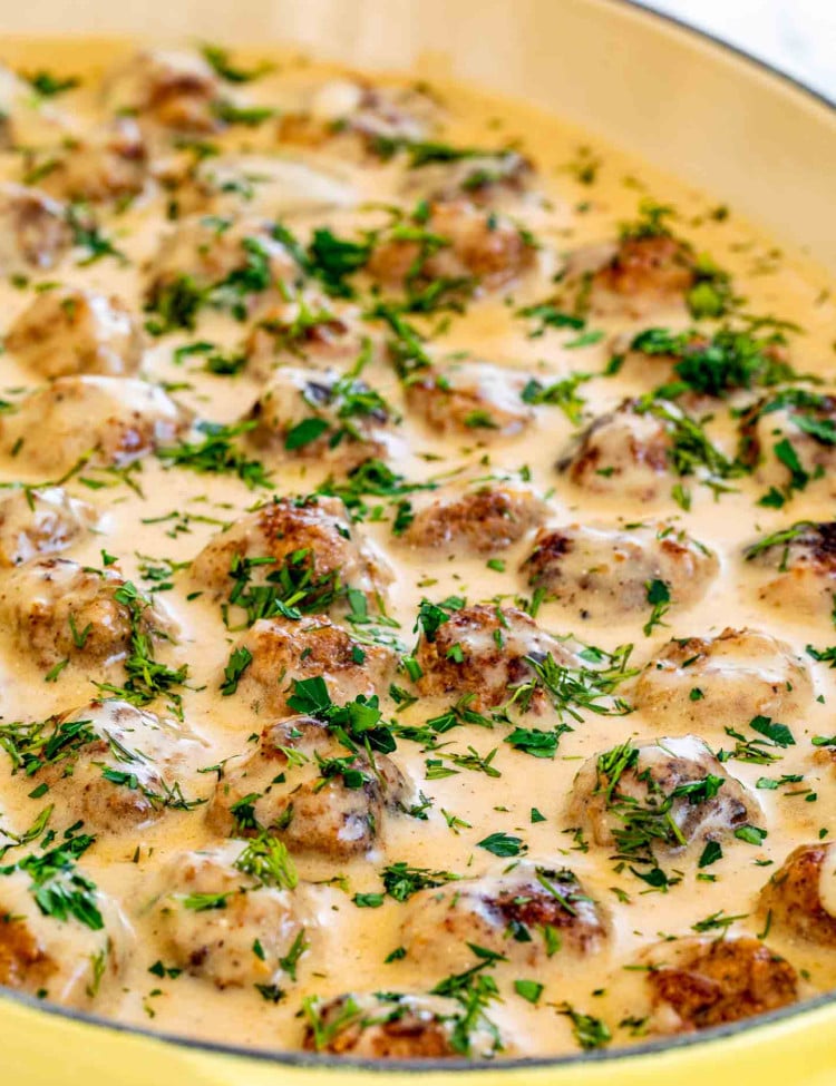 instant pot swedish meatballs in a yellow cast iron dish.