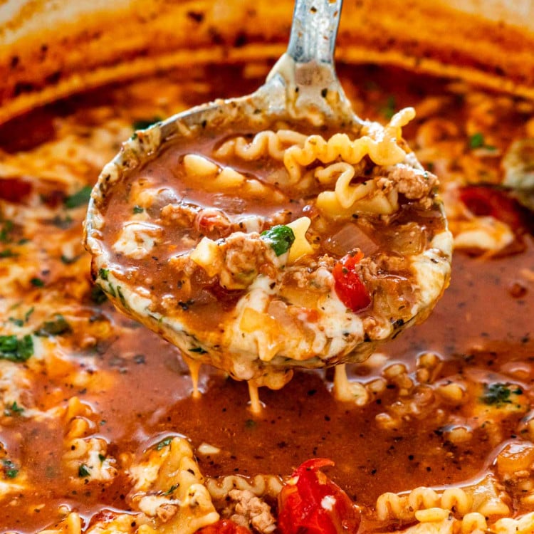 lasagna soup in a dutch oven with a ladle inside.