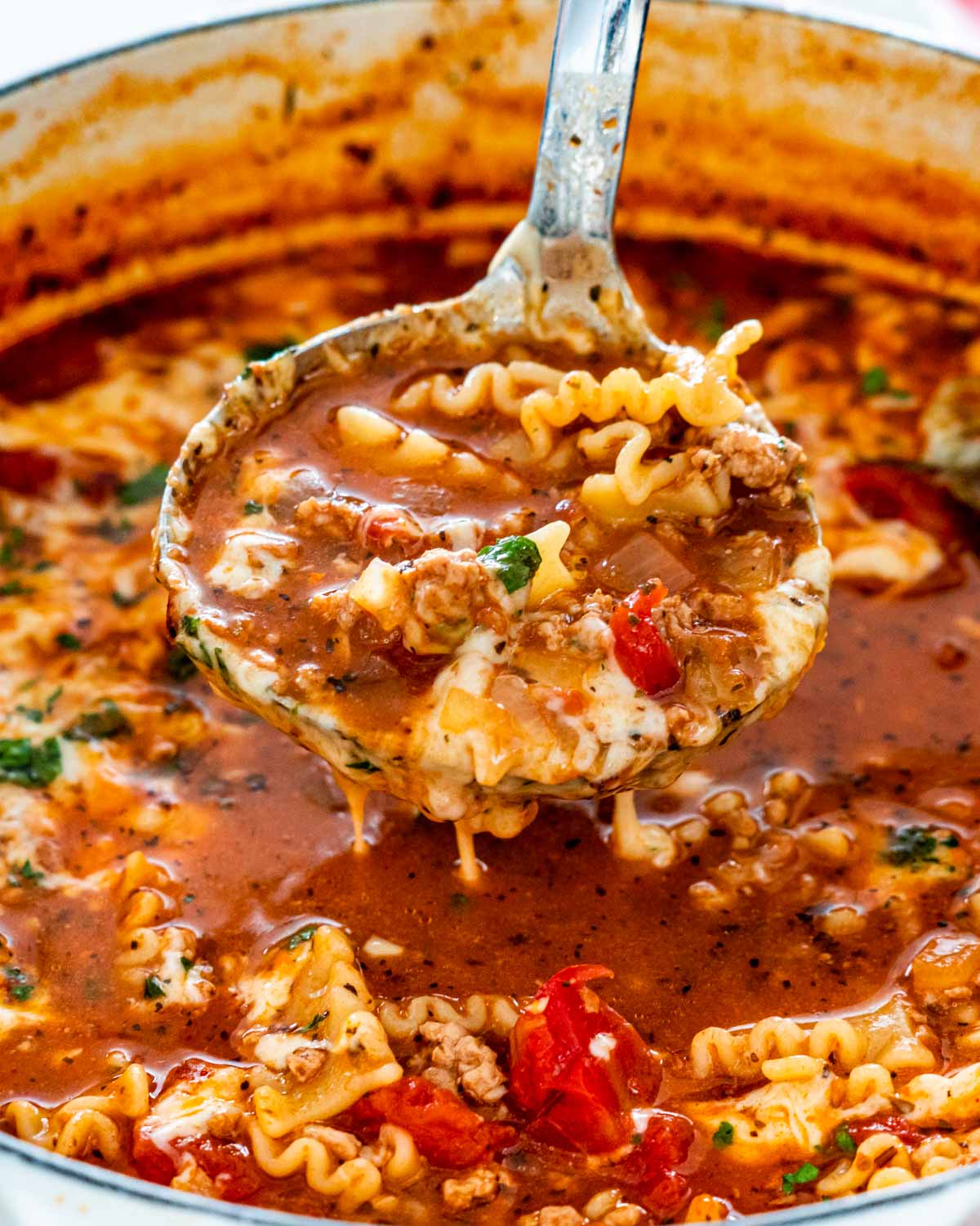 lasagna soup in a dutch oven with a ladle inside.