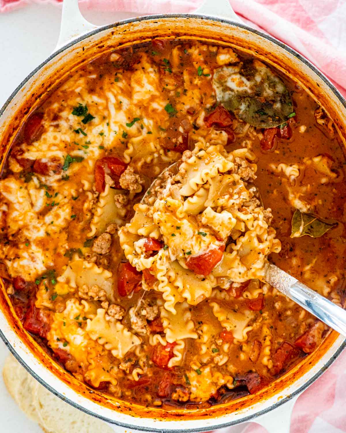 lasagna soup in a dutch oven with a ladle inside.